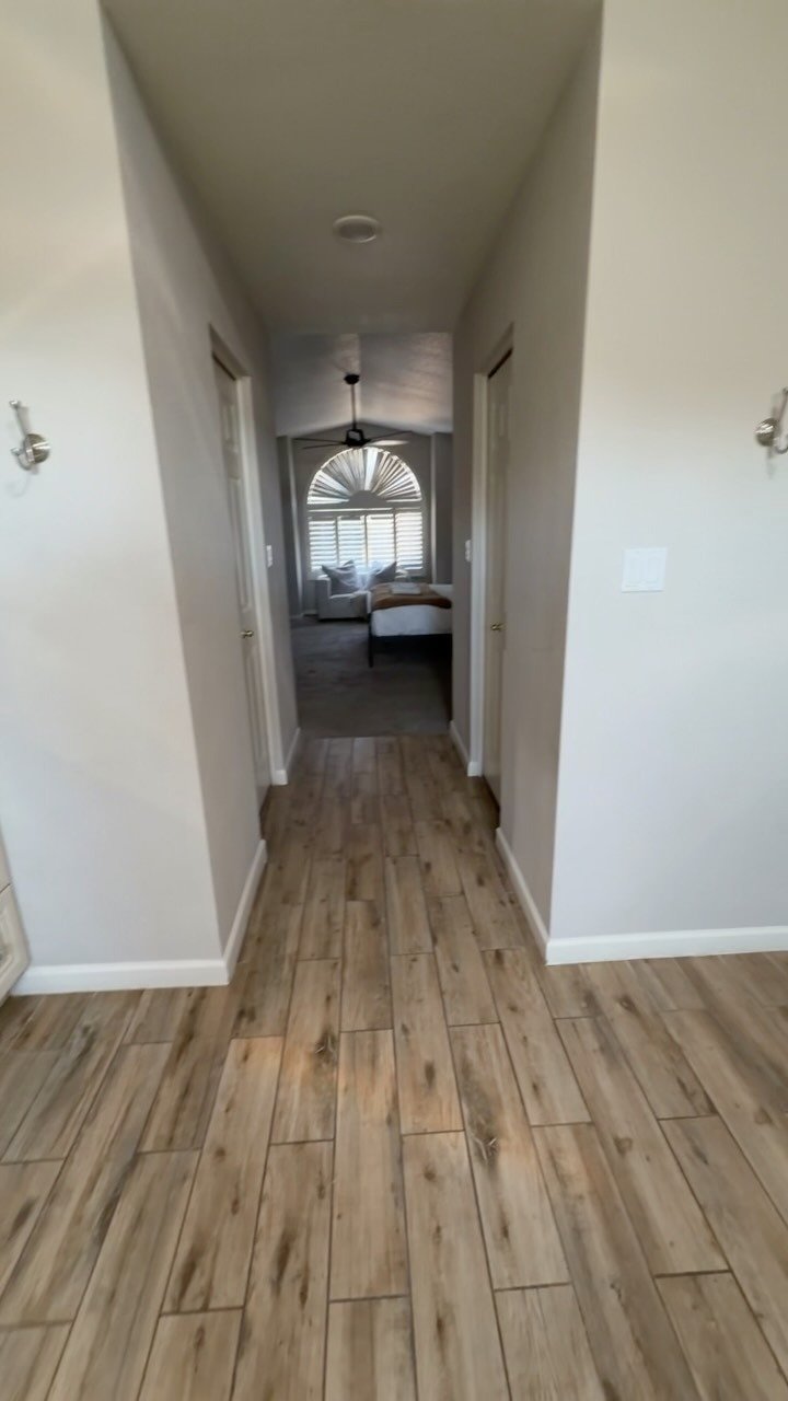 Hallway with wood-look plank tile flooring